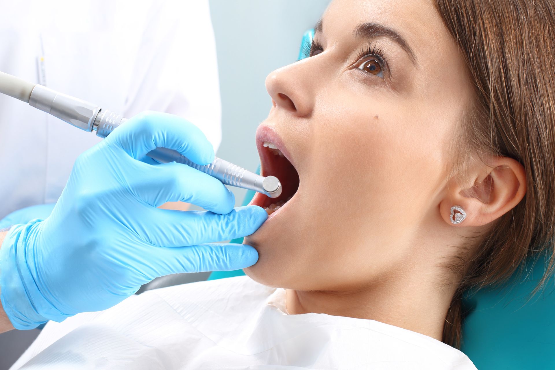 a women's dental health is checking up by a dentist